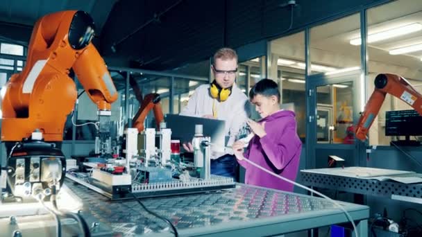 Boy Researching Bionic Arm His Tutor — Vídeo de stock