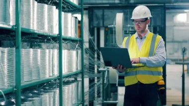 Male worker is doing inventory of fiberglass in the storage. 4K