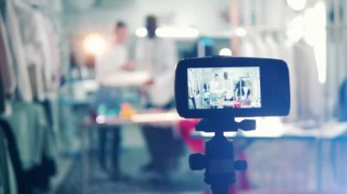 A camera is shooting two dressmakers working together. 4K