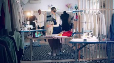 Dressmakers are exchanging threads in the workshop. 4K