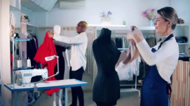 Designers are dressing up mannequins in the studio. 4K