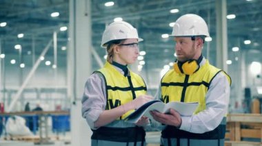 Two engineers are analyzing instructions together. 4K