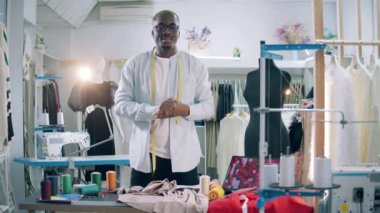 African dressmaker is filming a vlog in the workshop. 4K