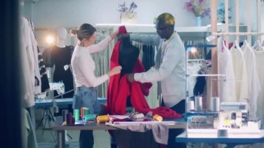 Two designers are dressing up a mannequin. 4K