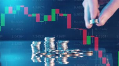 Changing stock rates and a hand adding coins to a pile. 4K