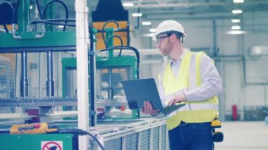 Industrial engineer is observing production process. 4K