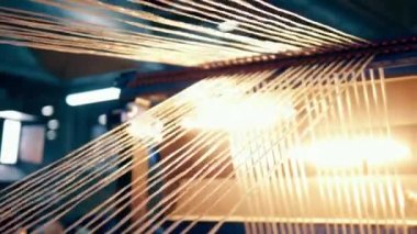 Illuminated strings of fiberglass getting mechanically stretched. 4K