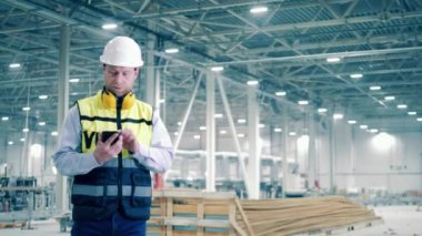 Industrial engineer starts talking on the phone. 4K