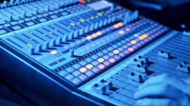 Professional mixing console is being operated by a specialist. 4K