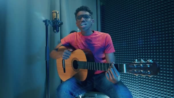 Young African Man Playing Guitar Singing Studio — Stock Video
