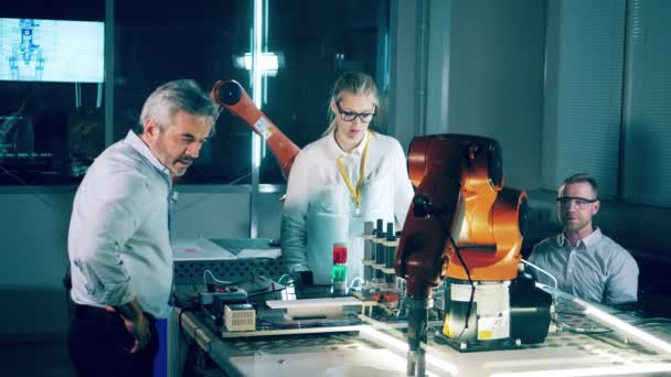 Engineers Discussing Robots Laboratory — стоковое видео