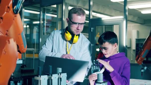 Boy Observing Bionic Hand His Tutor — Video Stock