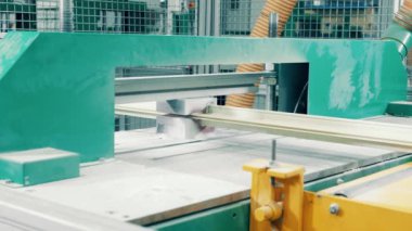 A bar of fiberglass is going through the industrial machine. 4K