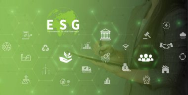 ESG environment social governance investment business concept. Women use a computer to analyze ESG, surrounded by ESG icons .close to the computer screen in business investment strategy concept.