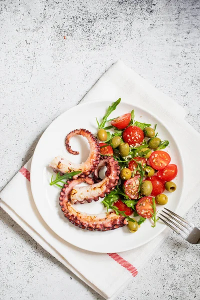 stock image salad with octopus, tomatoes, olives and arugula. fresh healthy salad.