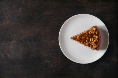 Koyu arkaplanda ev yapımı karamel fıstıklı cheesecake. Günaydın lezzetli pastane pastası..