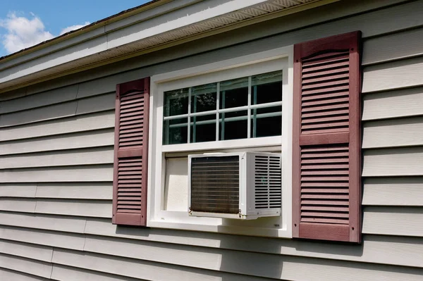 Stock image Air conditioner in house window on Summer day.