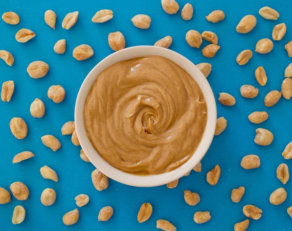 Smooth Creamy Peanut Butter Peanuts Blue Top View — Stock Photo, Image