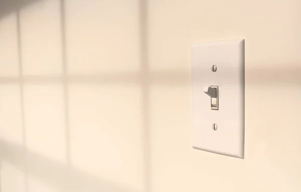 stock image Interior toggle light switch on wall during the daytime