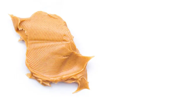 Smooth and creamy peanut butter spread on white