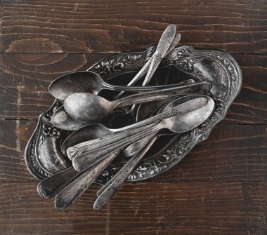 Overhead shot of rustic old spoons on wood