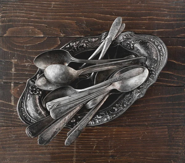 Overhead shot of rustic old spoons on wood