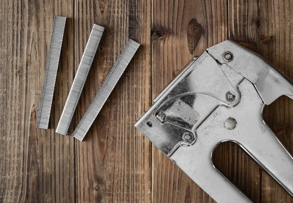 stock image Overhead view of industrial staple gun on wood