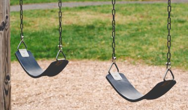 Detail shot of an empty playground swing