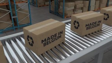 Cardboard boxes with Made in Belgium on conveyor belt line isolated on warehouse background