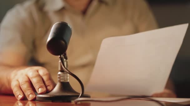 Ein Mann Liest Den Text Aus Papier Vor Dem Mikrofon — Stockvideo