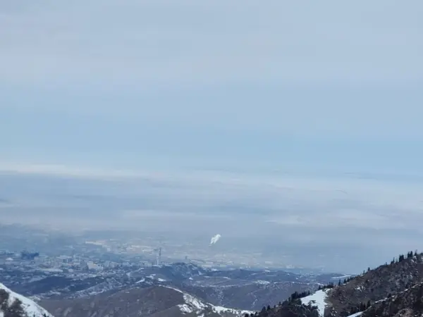winter view with snow of the city from the mountains. air pollution in the city