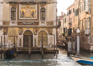 Beautiful old building facades and boats on the canal in Venice, Italy