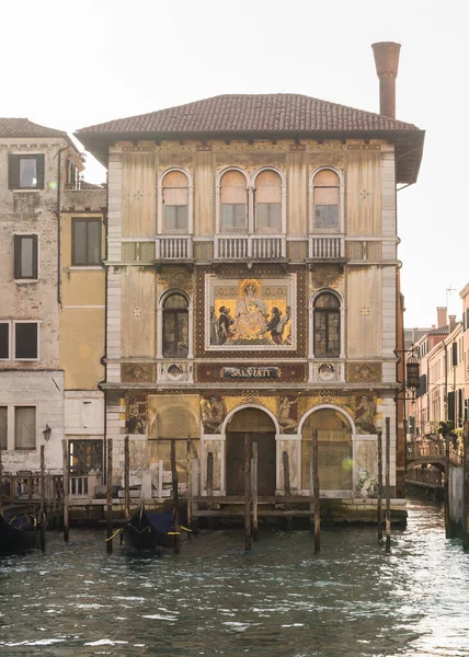 Beautiful old building facades and boats on the canal in Venice, Italy