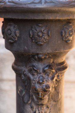 Closeup detail of an old drinking water fountain in Venice, Italy