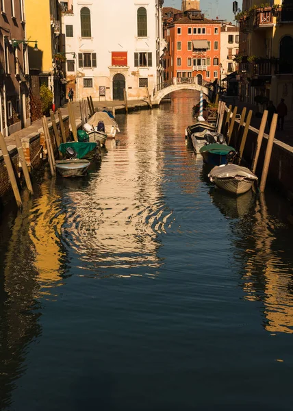 Boats docked on a canal in Venice, Italy