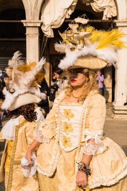 People wearing colorful and elaborate masks during the Venice carnival in Venice, Italy