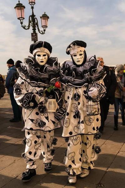 People wearing colorful and elaborate masks during the Venice carnival in Venice, Italy