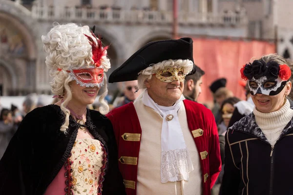 People wearing colorful and elaborate masks during the Venice carnival in Venice, Italy