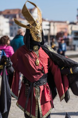 People wearing elaborate and colorful costumes and masks during the Venice 2023 carnival in Venice, Italy