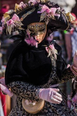 People wearing elaborate and colorful costumes and masks during the Venice 2023 carnival in Venice, Italy