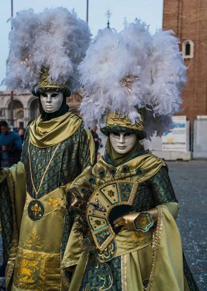 People wearing elaborate and colorful masks and costumes during the Venice carnival in Italy