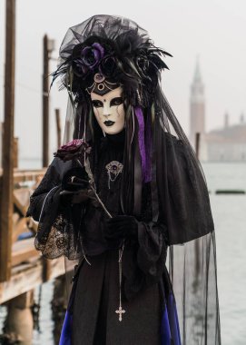 People wearing colorful and elaborate masks and costumes during the Venice carnival in Italy