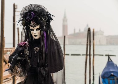 People wearing colorful and elaborate masks and costumes during the Venice carnival in Italy