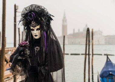 People wearing colorful and elaborate costumes during the Venice carnival in Italy 
