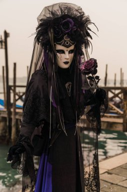 People wearing costumes during the Venice carnival in Italy 