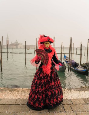 People wearing colorful and elaborate masks and costumes during the Venice carnival in Italy