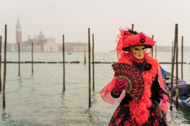 People wearing colorful and elaborate costumes during the Venice carnival in Italy 