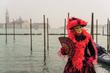People wearing colorful and elaborate costumes during the Venice carnival in Italy 
