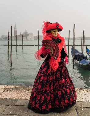 People wearing colorful and elaborate costumes during the Venice carnival in Italy 
