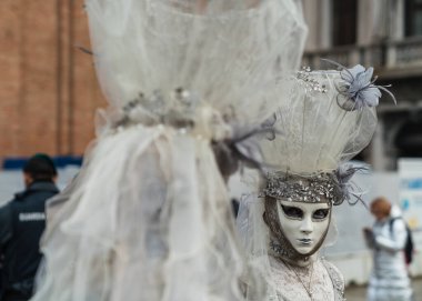 People wearing colorful and elaborate costumes during the Venice carnival in Italy 